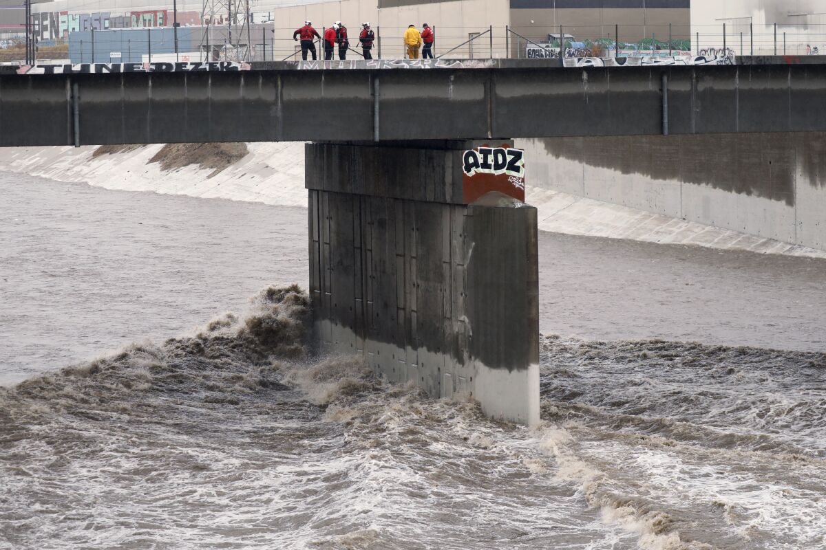 Storm water roars down the L.A. River near downtown Los Angeles on Dec. 14.