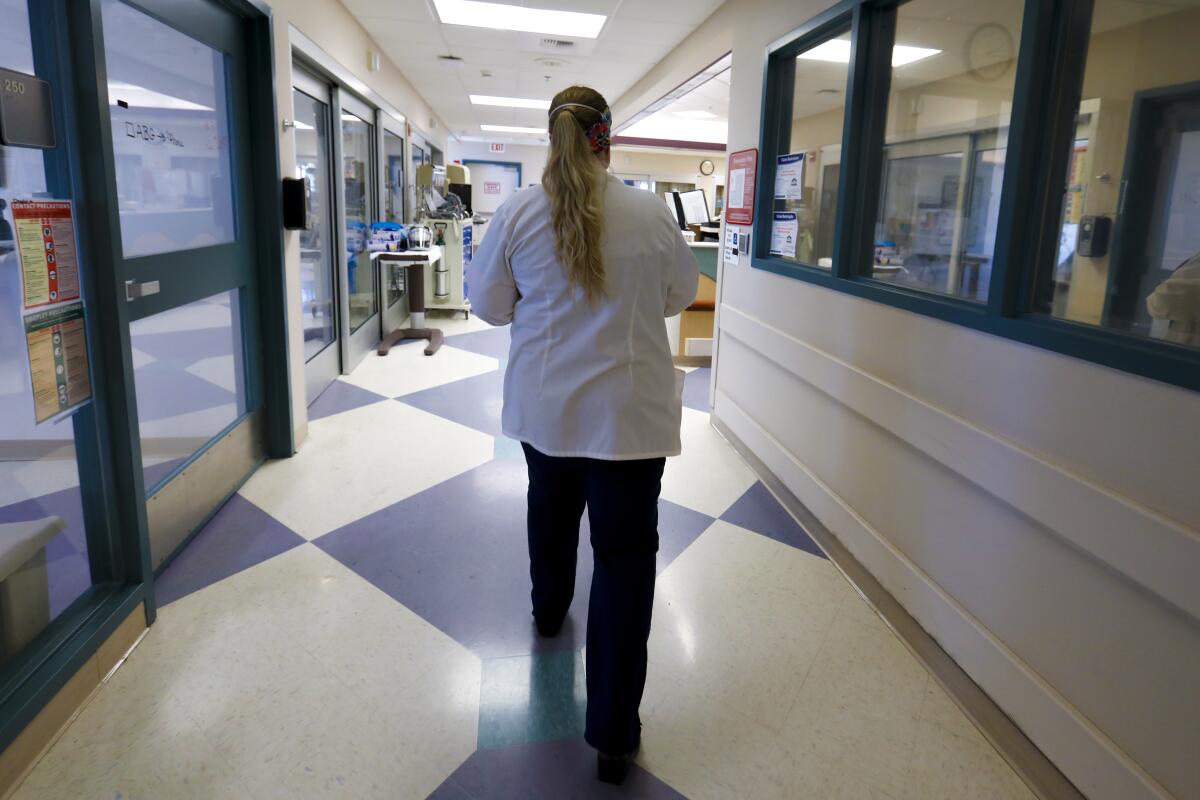 Judy Cruz, RN and emergency room director, walks through the COVID unit at El Centro Regional Medical Center.