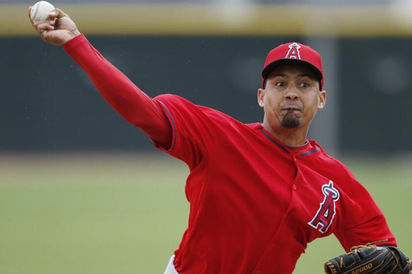 Angels closer Ernesto Frieri delivers a pitch during a spring-training practice session Feb. 25. Frieri make a brief spring-training debut for the Angels in a 3-2 exhibition win over the Arizona Diamondbacks on Monday.