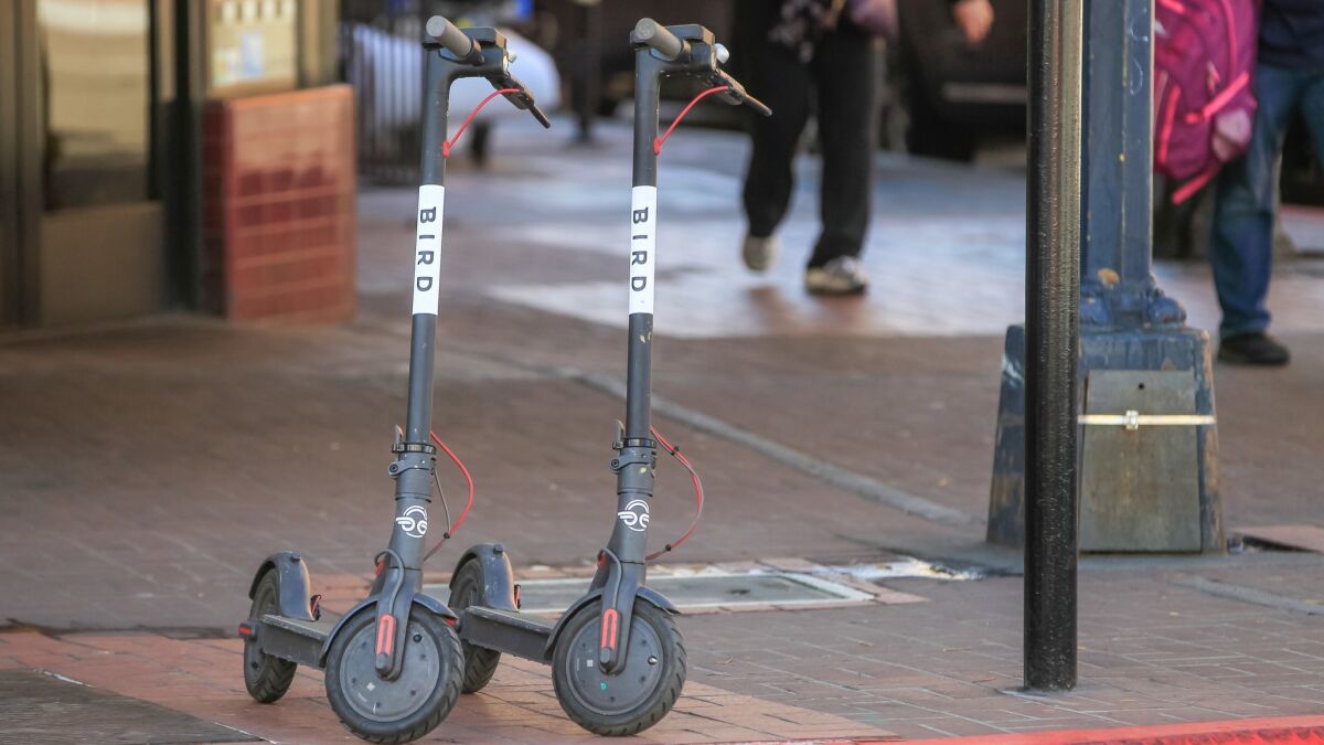 SAN DIEGO, CA March 1st 2018 | These are two Bird scooters placed on the sidewalk at E Street and 4th Avenue