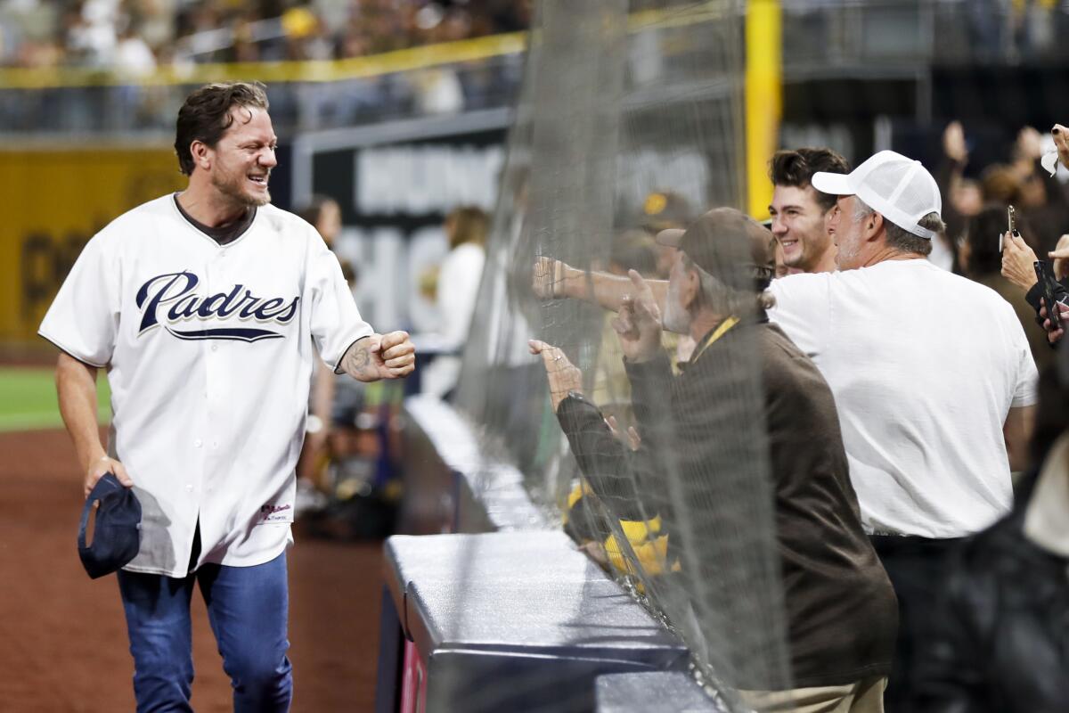Former San Diego Padres pitcher Jake Peavy greets fans before game 4 of the NLDS 
