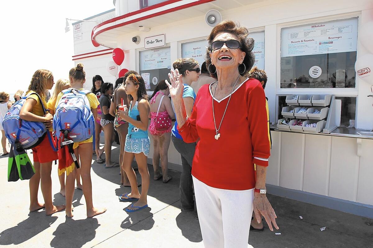 Ruby Cavanaugh, the namesake for Ruby's Diner, waves to guests at the original restaurant at the end of the Balboa Pier in 2012, when the chain turned 30. Cavanaugh died Sunday at age 93.