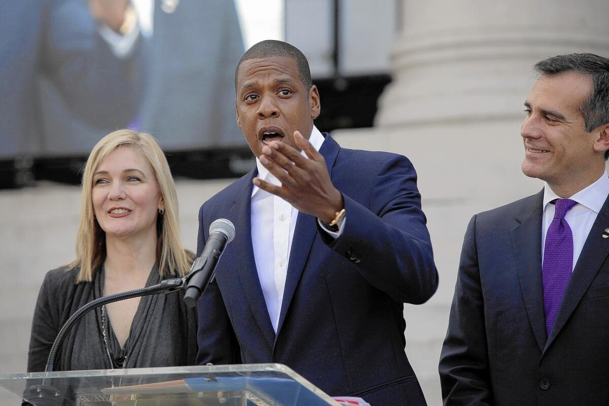 United Way President Elise Buik, rapper Jay Z and L.A. Mayor Eric Garcetti hold a news conference to announce that Jay Z's popular Made in America music festival will be held at Grand Park over the Labor Day weekend.