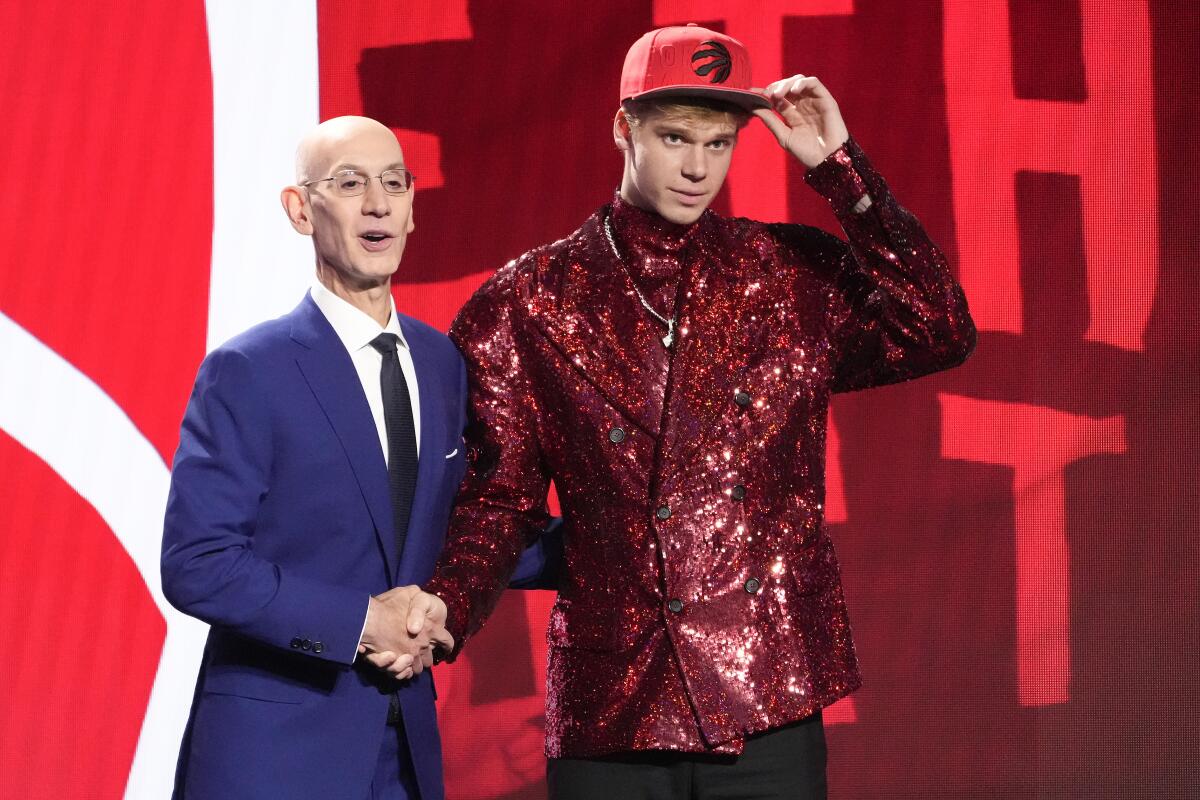 Former Kansas guard Gradey Dick poses with Commissioner Adam Silver after being selected 13th overall by the Toronto Raptors.