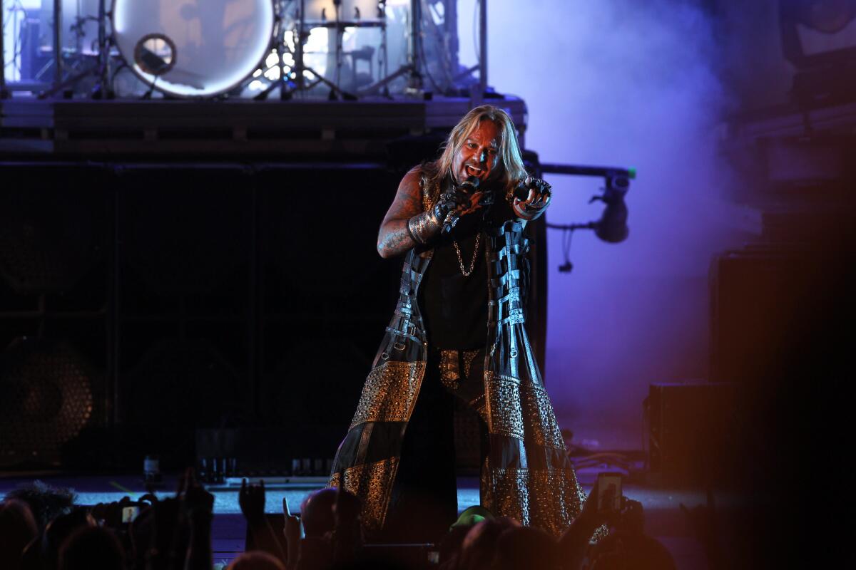Motley Crue frontman Vince Neil revs up the crowd during a victory lap Monday night at the Hollywood Bowl as part of the band's farewell tour.