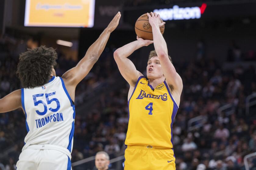 Los Angeles Lakers guard Dalton Knecht (4) looks to shoot past Golden State Warriors forward Ethan Thomopson (55) during the first half of an NBA summer league basketball game in San Francisco, Sunday, July 7, 2024. (AP Photo/Nic Coury)