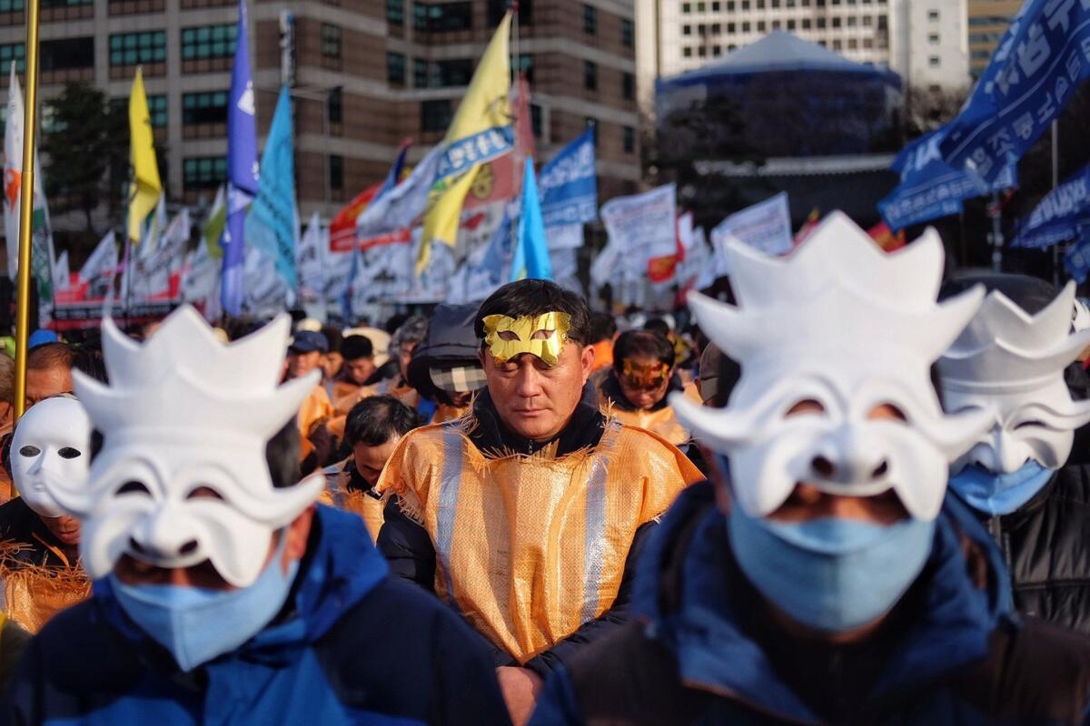 Protesters wearing masks take part in an anti-government rally in Seoul on Saturday.