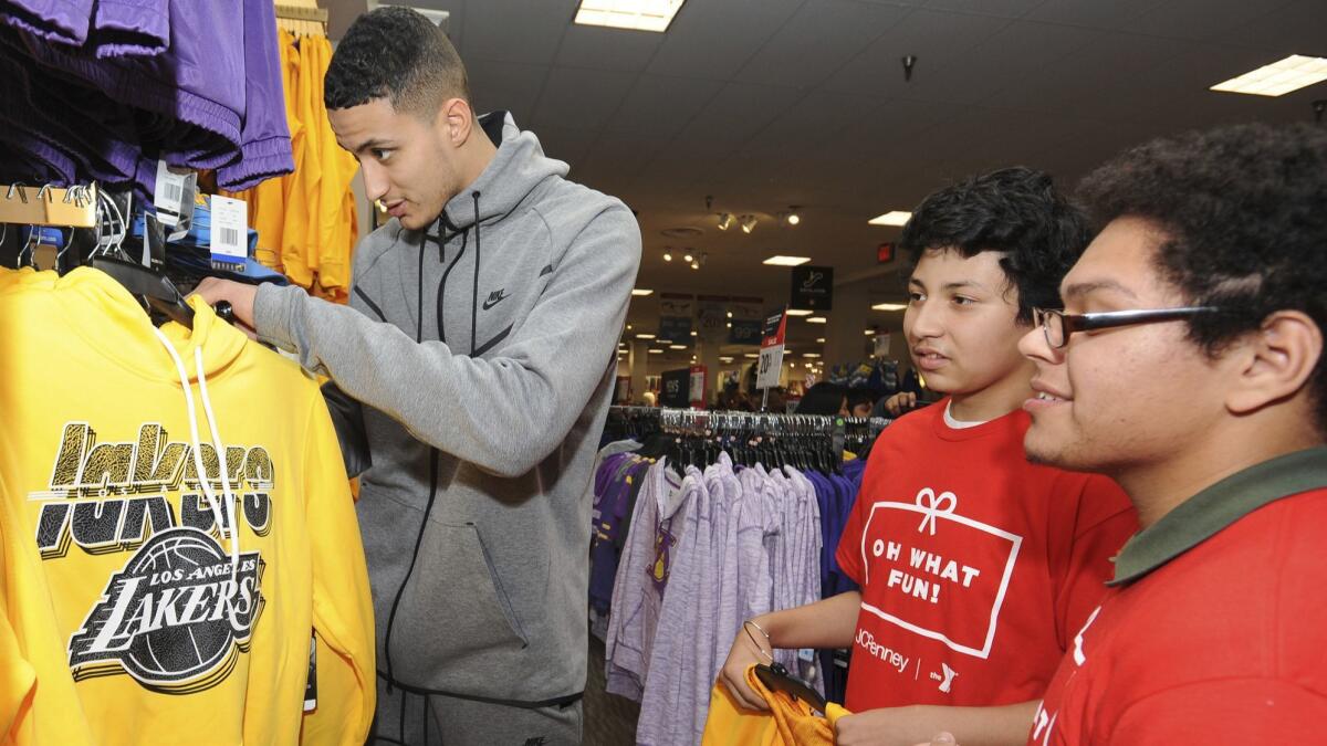 Lakers forward Kyle Kuzma helps pick out apparel for youths from Weingart East Los Angeles YMCA the Glendale Galleria on Tuesday in a partnership with JCPenney..