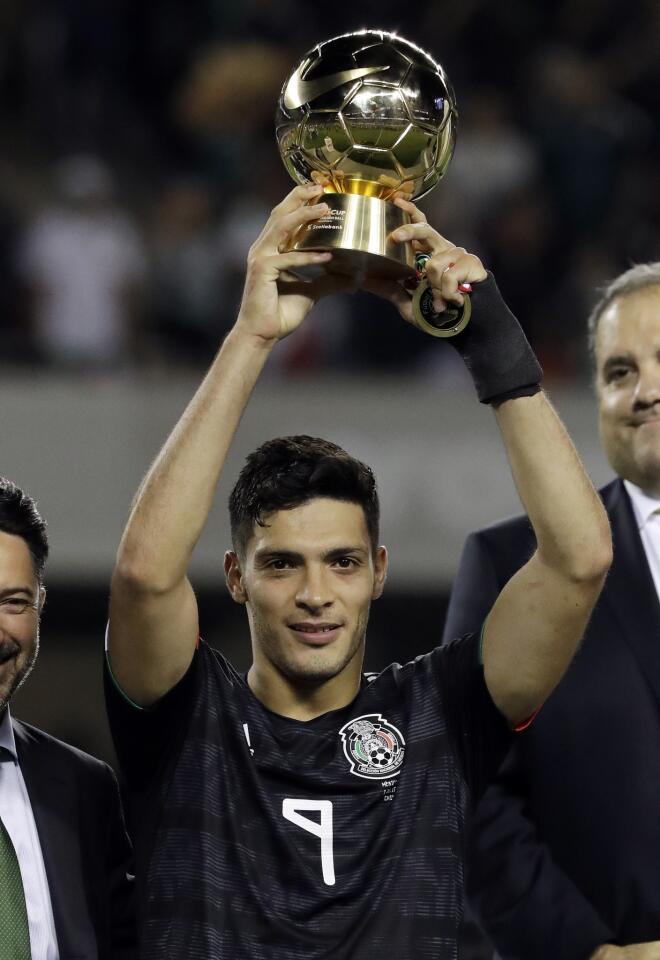 Mexico's forward Raul Jimenez holds up the Golden Bowl trophy after Mexico defeated United States 1-0 in the CONCACAF Gold Cup final soccer match at Soldier Field in Chicago, Sunday, July 7, 2019.