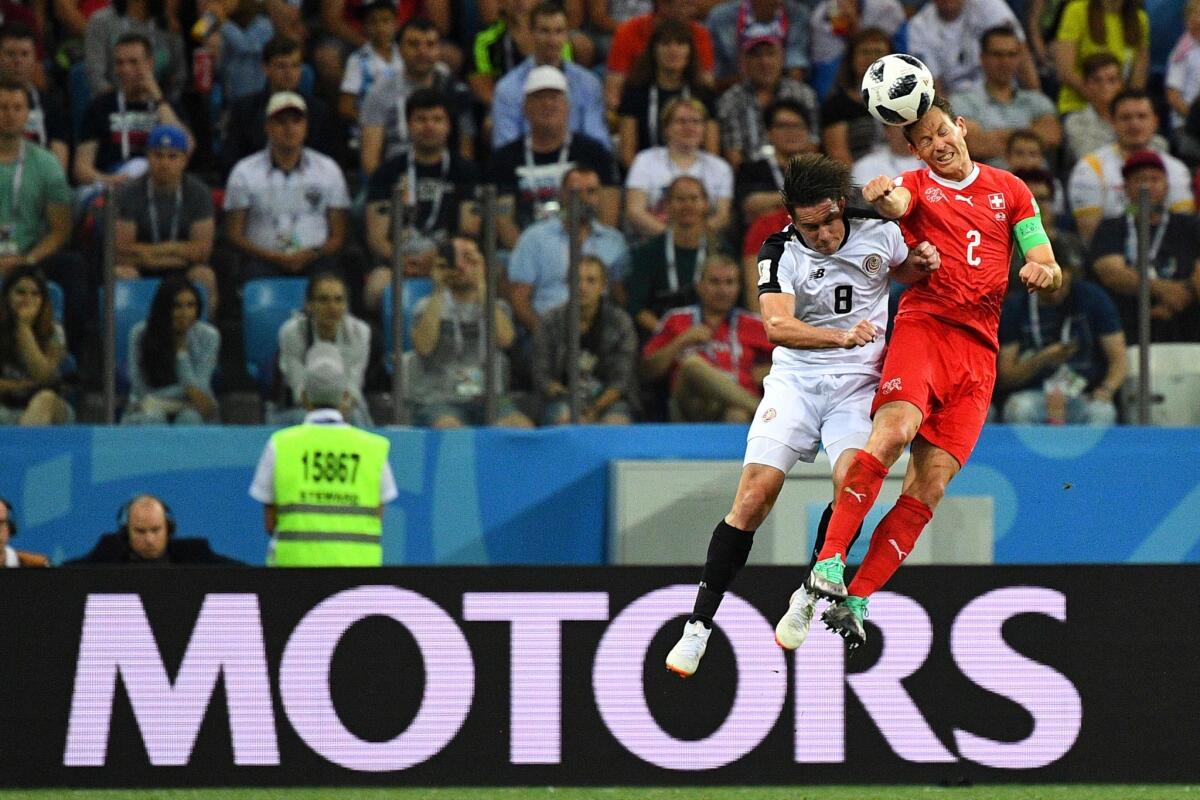 Costa Rica's Bryan Oviedo, left, and Switzerland's defender Stephan Lichtsteiner