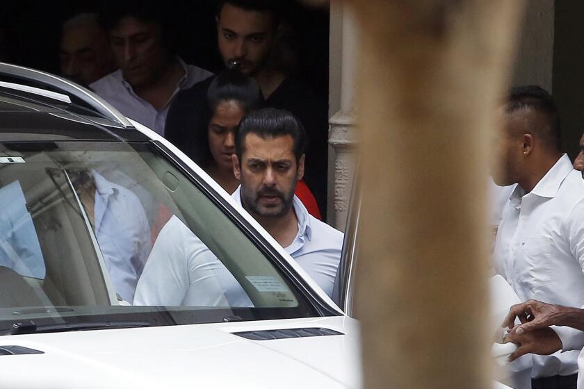 Bollywood actor Salman Khan, center, leaves his residence to travel to court in Mumbai, India, on May 8.