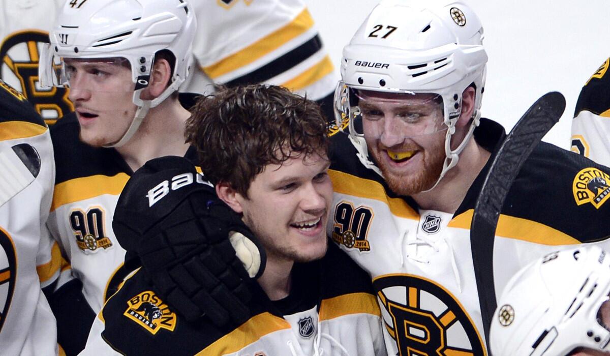 Bruins right wing Matt Fraser (without helmet) celebrates with teammates, including defenseman Dougie Hamilton, after scoring the winning goal against the Montreal Canadiens in the first overtime on Wednesday night.