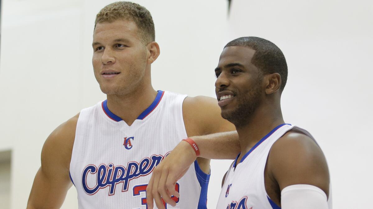 Blake Griffin, left, and Chris Paul pose for photographs during the Clippers' media day on Monday.