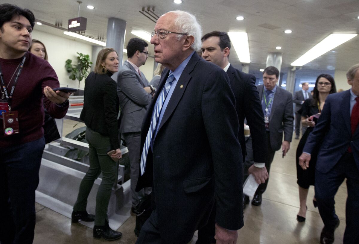 Sen. Bernie Sanders of Vermont walks to the Senate chamber Wednesday for the impeachment trial of President Trump.