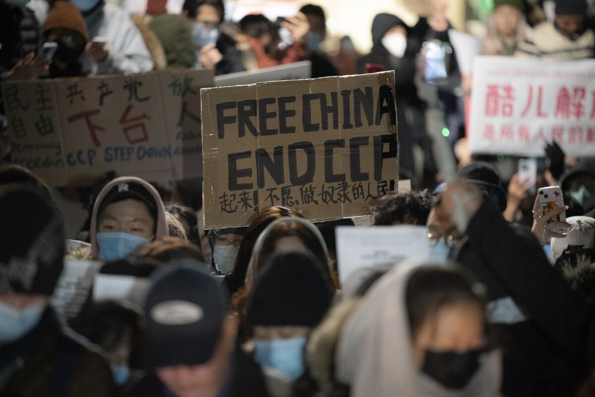 Manifestantes se reúnen cerca del consulado chino en solidaridad con sus contrapartes de todo el mundo que protestan contra las severas restricciones relacionadas con el COVID-19 en China, el martes 29 de noviembre de 2022, en Nueva York. (AP Foto/John Minchillo)