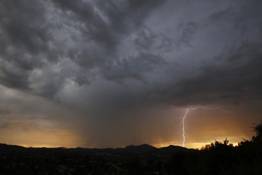 THOUSAND OAKS, CA - OCTOBER 04: Lighting strikes to the West over the Oxnard plain as seen from Thousand Oaks as rain, thunder and lightning hit the southland by surprise Monday October 4, 2021 Thousand Oaks on Monday, Oct. 4, 2021 in Thousand Oaks, CA. (Al Seib / Los Angeles Times).