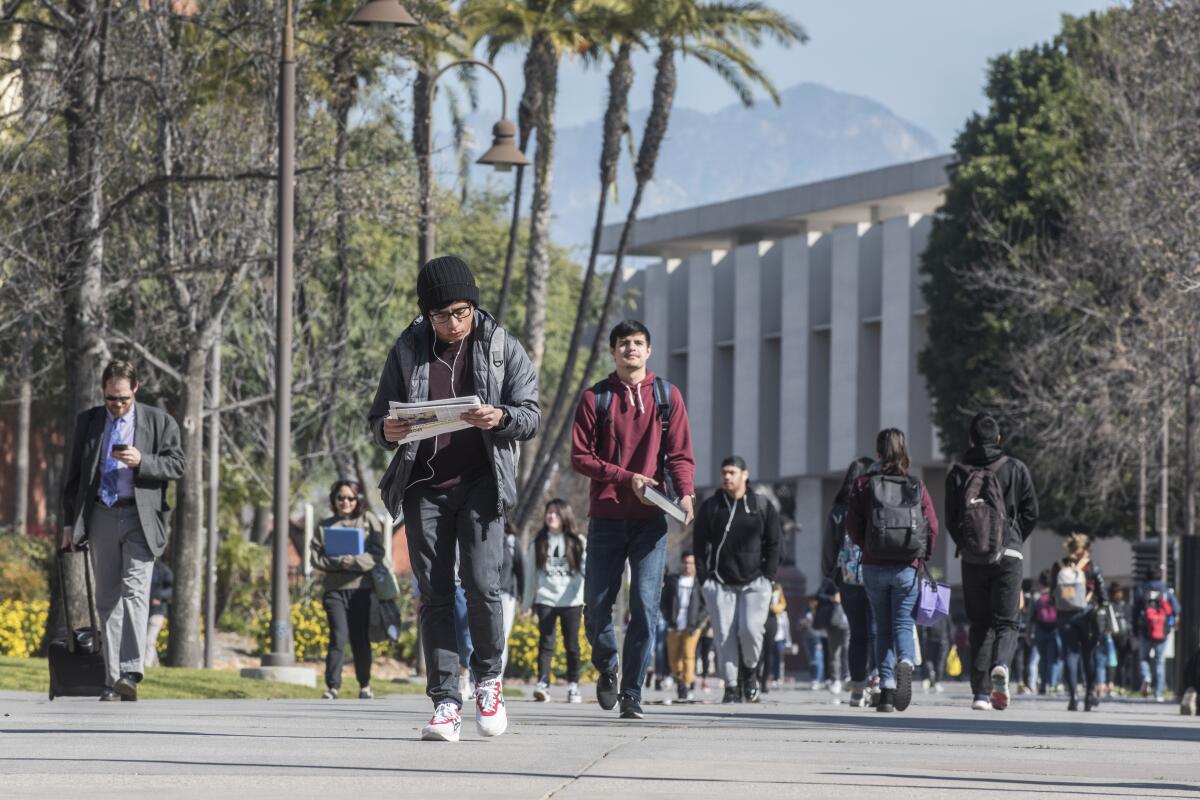 Students walk on the campus of Cal State Los Angeles on Monday morning, Feb. 25, 2018. The university wants to raise its admissions requirements to reduce the number of qualified applicants it is forced to turn away. (Photo by Nick Agro / For The Times)