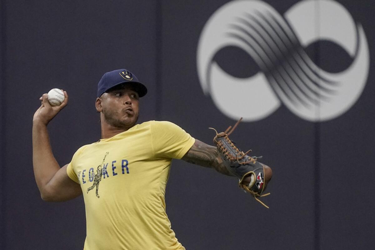 Milwaukee Brewers' Freddy Peralta throws at a practice for the Game 1 of the NLDS baseball game Thursday, Oct. 7, 2021, in Milwaukee. The Brewers plays the Atlanta Braves in Game 1 on Friday, Oct. 8, 2021. (AP Photo/Morry Gash)