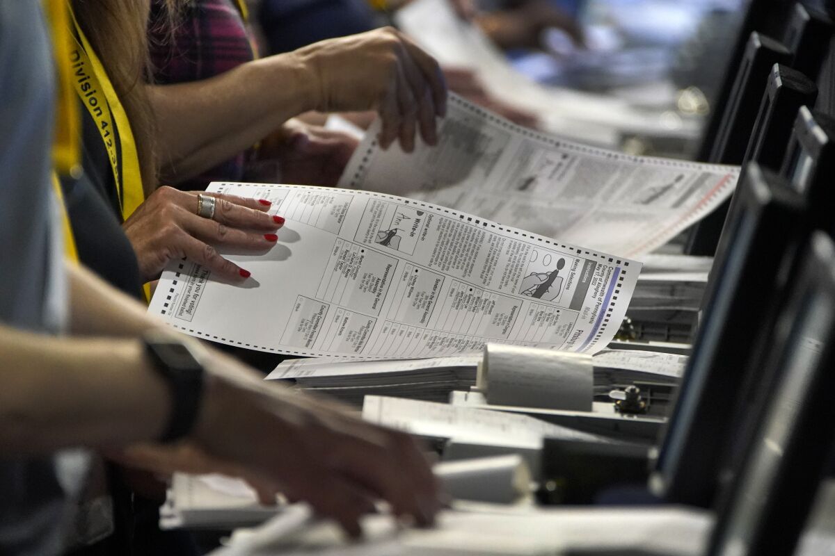 Election workers perform a recount of ballots from the recent Pennsylvania primary election.