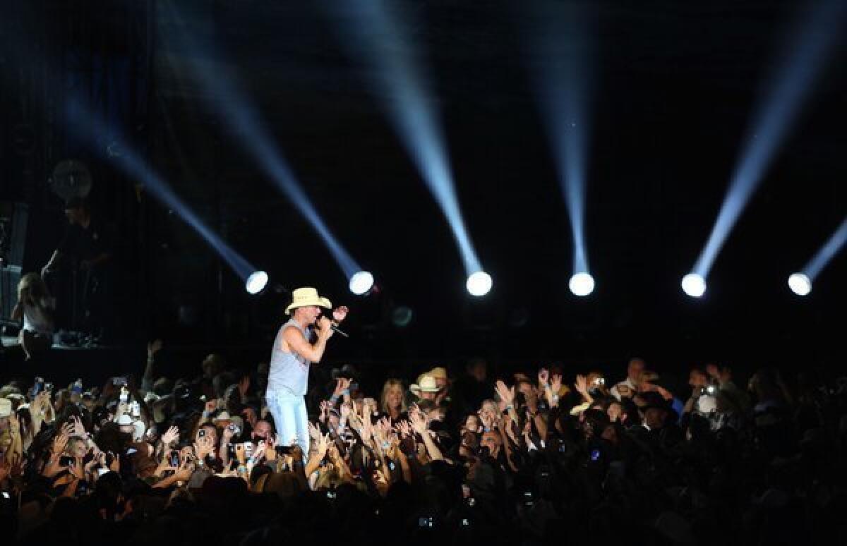 Kenny Chesney, seen during his Anaheim tour stop in July with Tim McGraw, is among the early winners for 2012 CMA Awards.