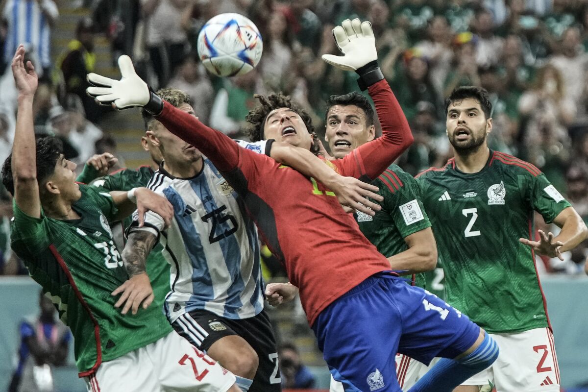 Mexico's goalkeeper Guillermo Ochoa goes for the ball during the World Cup group C soccer match between Argentina and Mexico, at the Lusail Stadium in Lusail, Qatar, Saturday, Nov. 26, 2022. (AP Photo/Hassan Ammar)