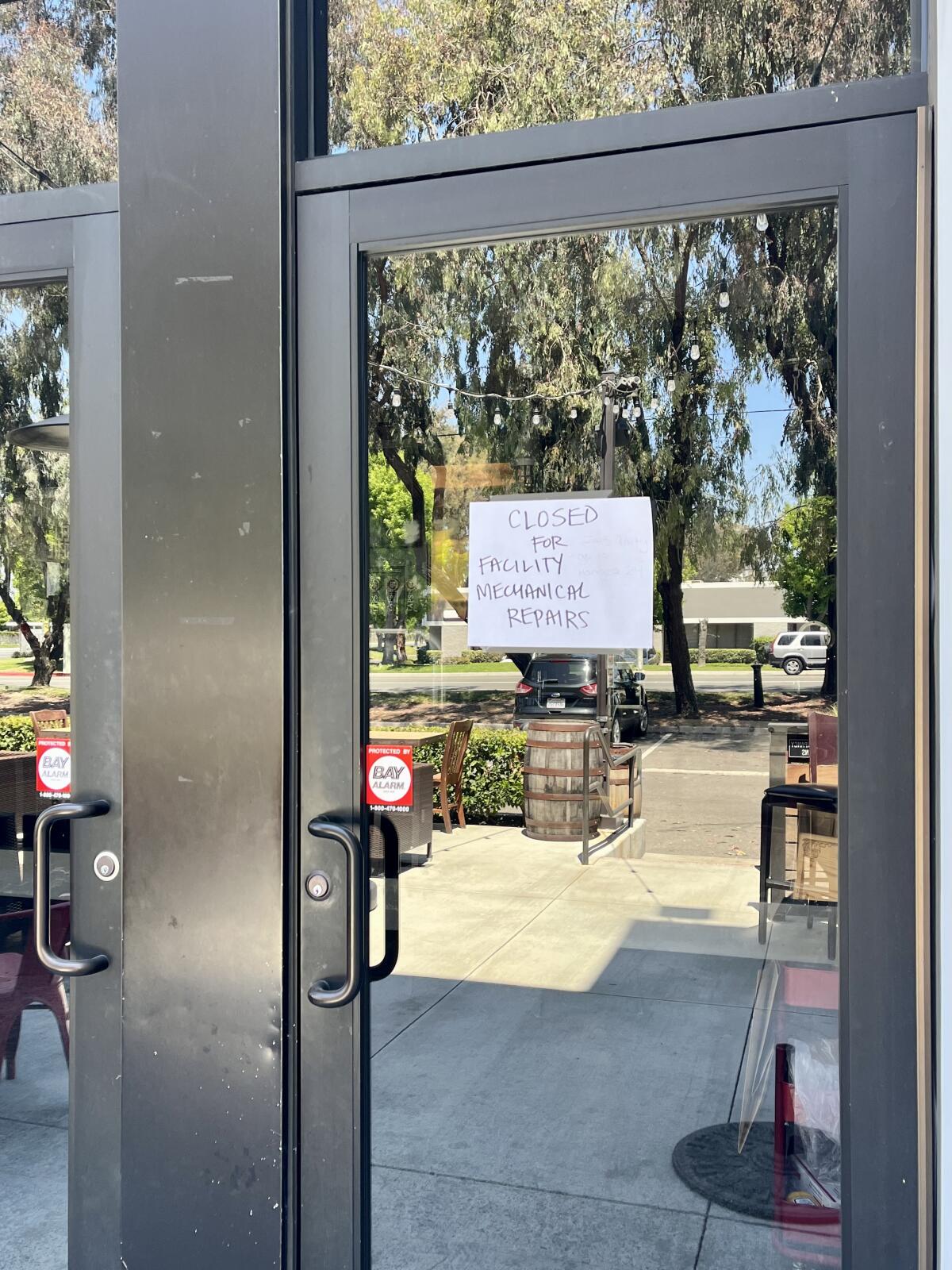 A "closed" sign on the door at TAPS Brewery & Barrel Room in Tustin cites "facility mechanical repairs."