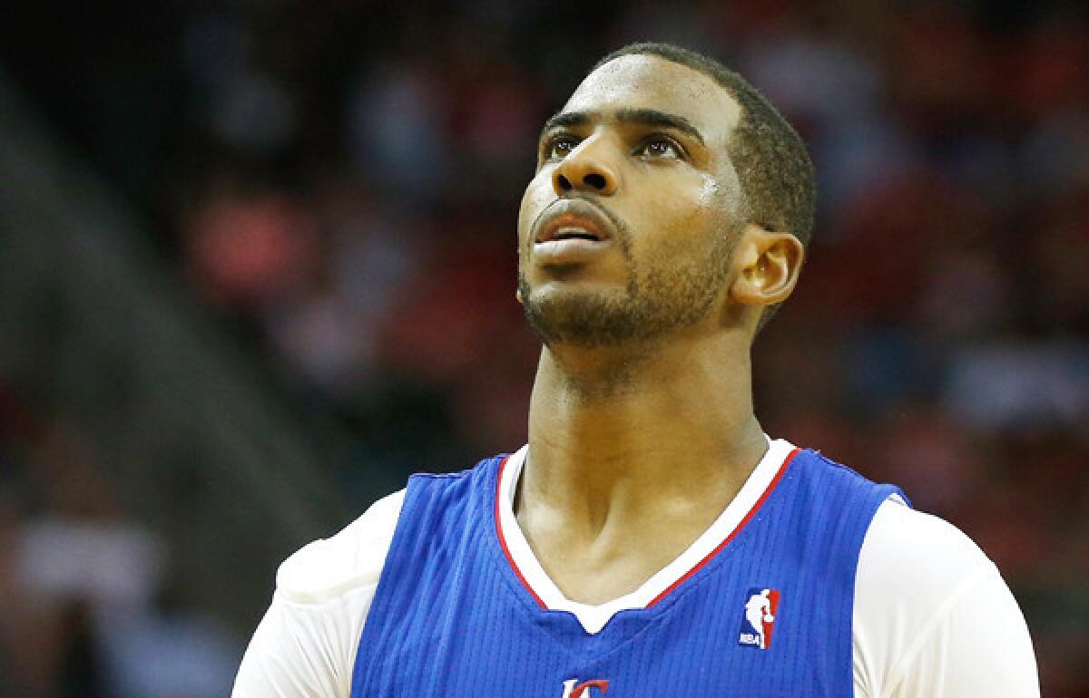 Clippers point guard Chris Paul checks out the video board during a game against the Rockets in Houston last week.