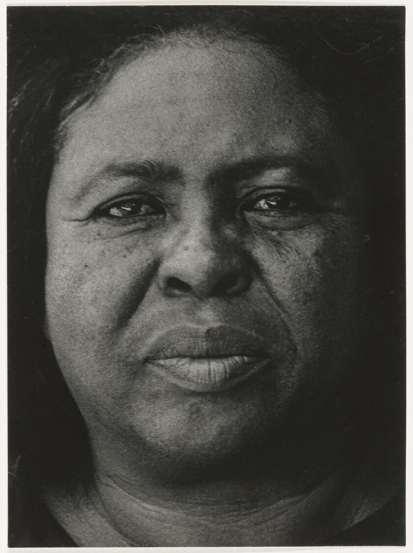 A close-up portrait of a woman in black and white