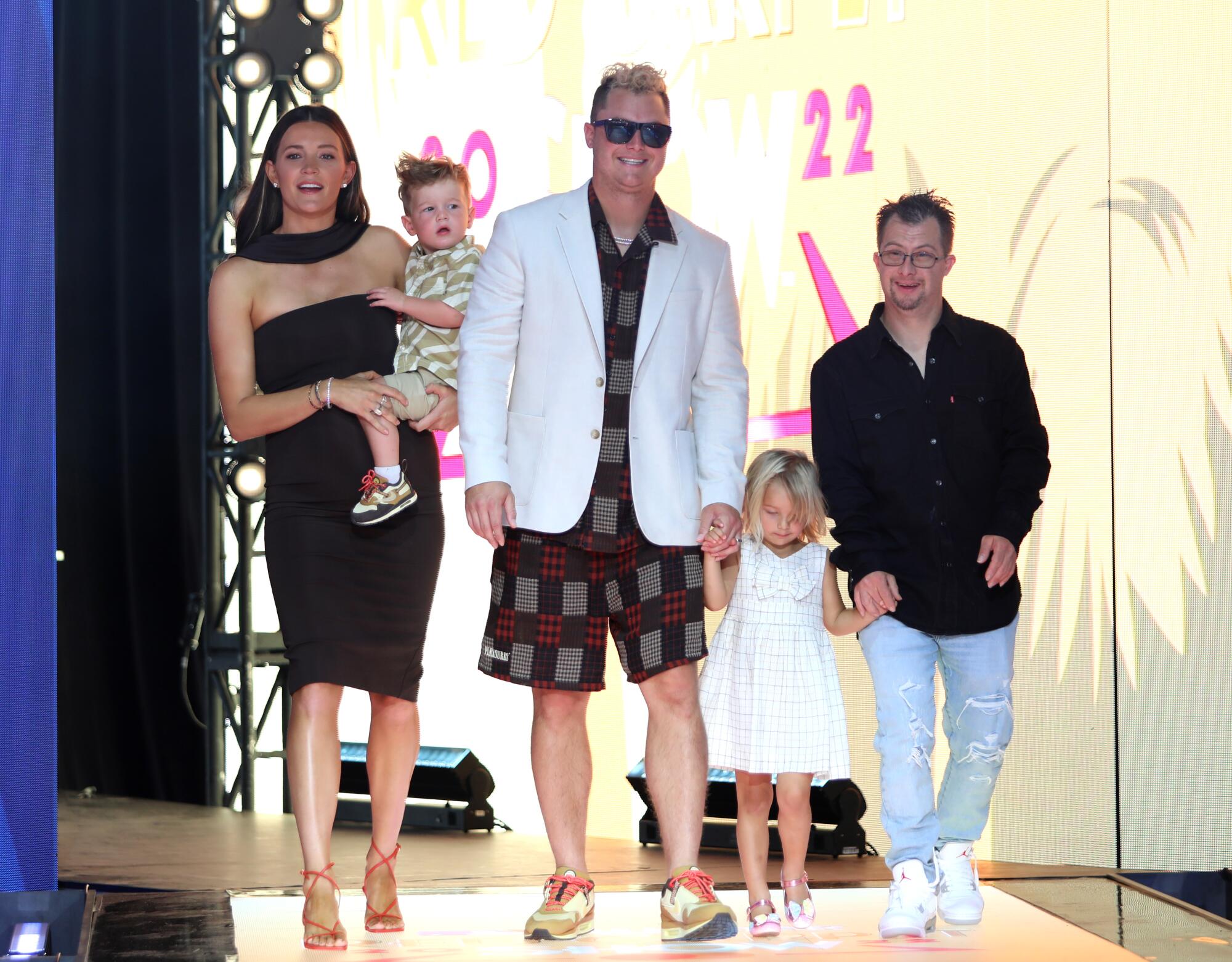 Joc Pederson in shorts and a shirt and jacket arrives with his family at the 2022 MLB All-Star Game Red Carpet Show.