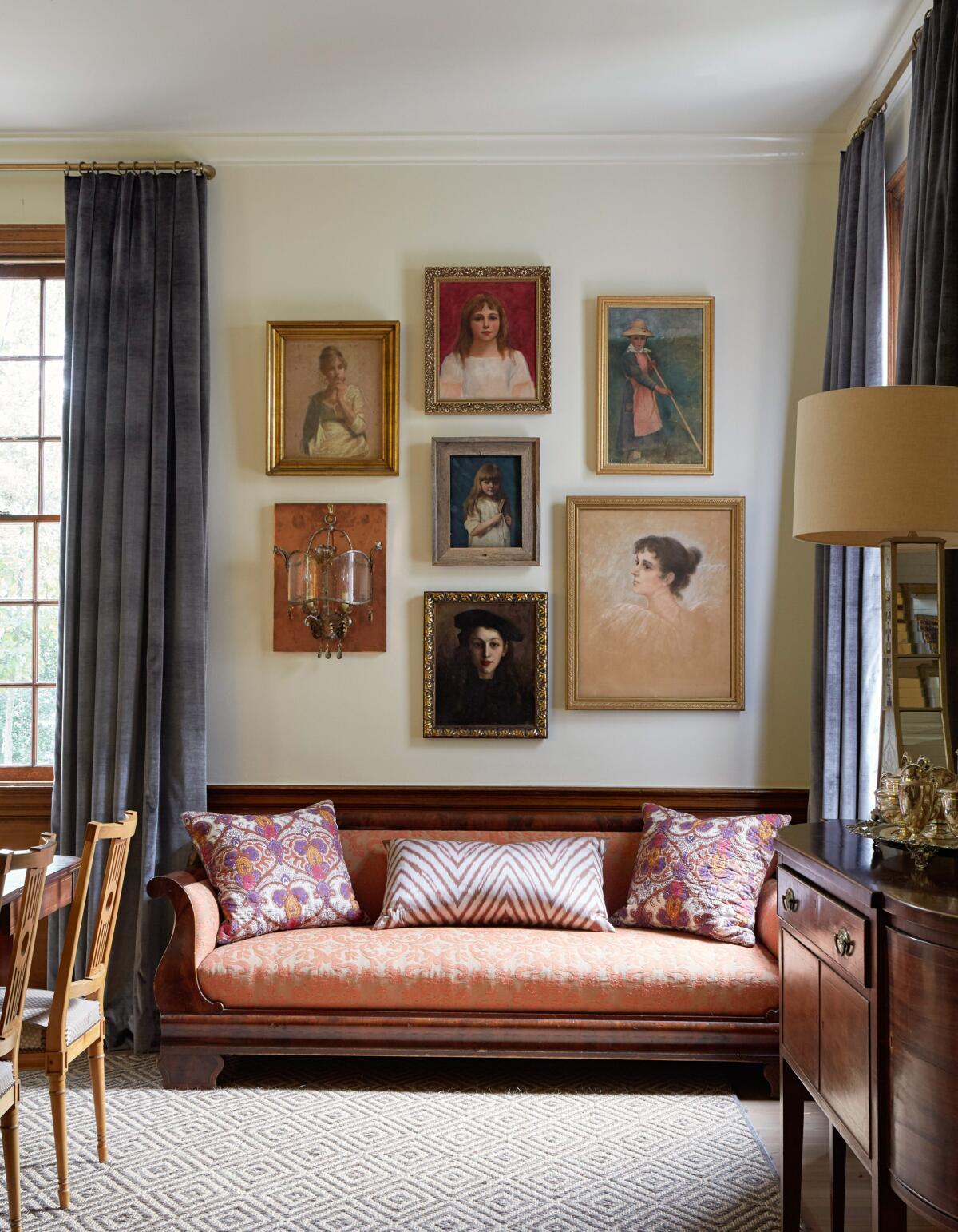 In this dining room, a selection of antique portraits inspired the furnishings and overall vibe of the space.