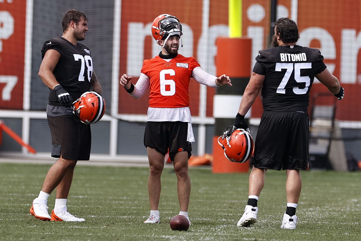 Cleveland Browns quarterback Baker Mayfield (6) talks with offensive tackle Jack Conklin (78) and guard Joel Bitonio (75) during practice at the NFL football team's training facility Friday, Aug. 14, 2020, in Berea, Ohio. (AP Photo/Ron Schwane)
