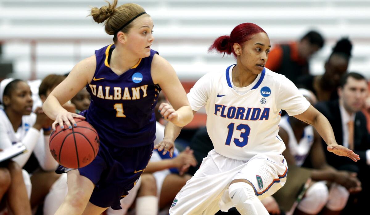 Albany guard Erin Coughlin drives against Florida guard Cassie Peoples during the first half Friday.