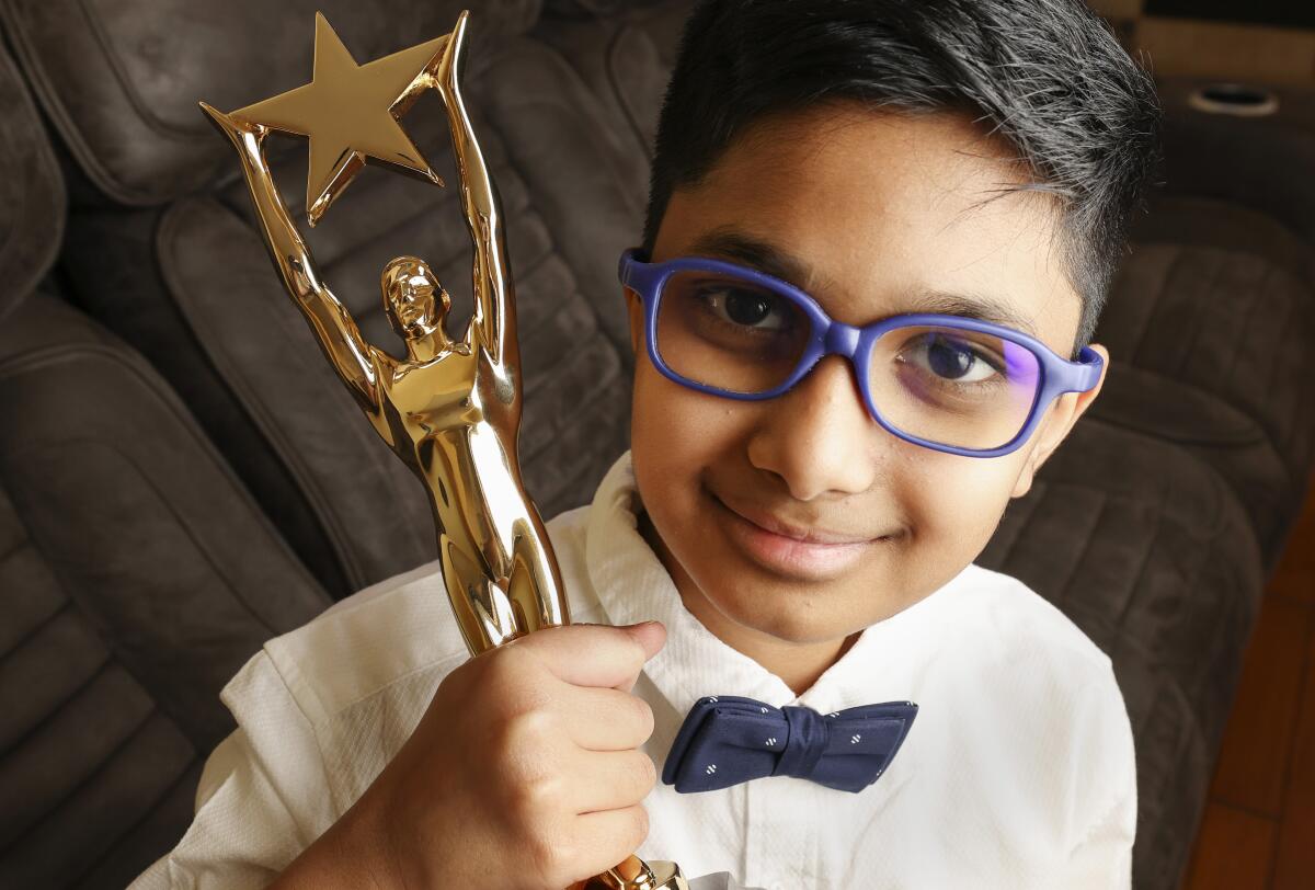 San Diego County spelling bee winner Mihir Konkapaka holds his trophy at his home