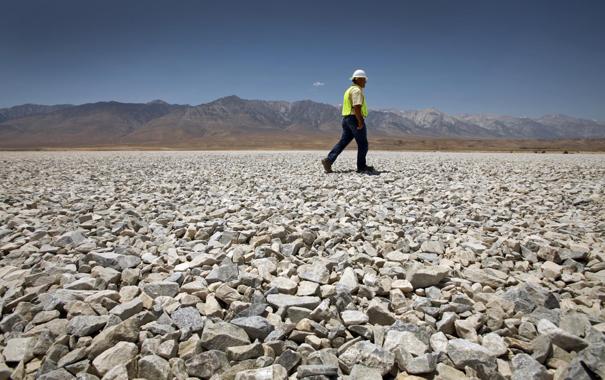 A DWP employee walks on the gravel project in Owens Lake in 2012.
