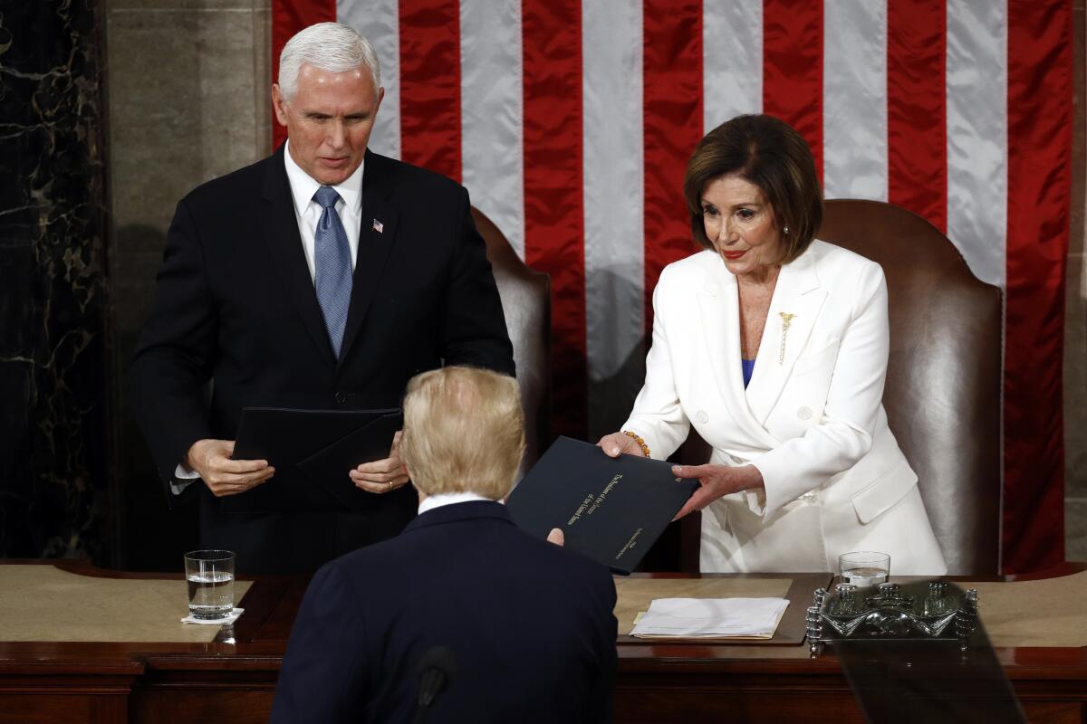 President Trump hands copies of his State of the Union speech to House Speaker Nancy Pelosi (D-San Francisco) and Vice President Mike Pence before delivering the address.