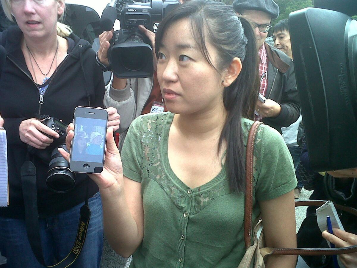Wen Zhang shows a picture of her son during a news conference in San Francisco.