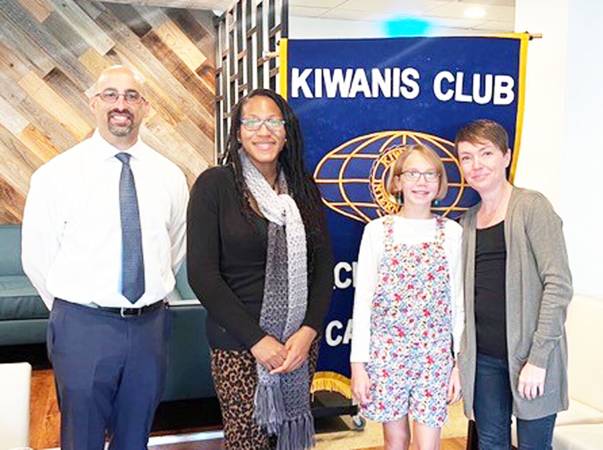 Kiwanian Tony Bayona, CPJMA Principal Sakeenah Smith, “Student of the Month” Amber Williams and her mother, Auburn Williams.