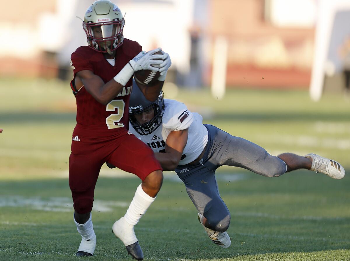 Alemany wide receiver Kevin Green Jr. makes a catch against Jordan High School (Utah)  defensive back Duane Nichols in the first quarter on Friday.