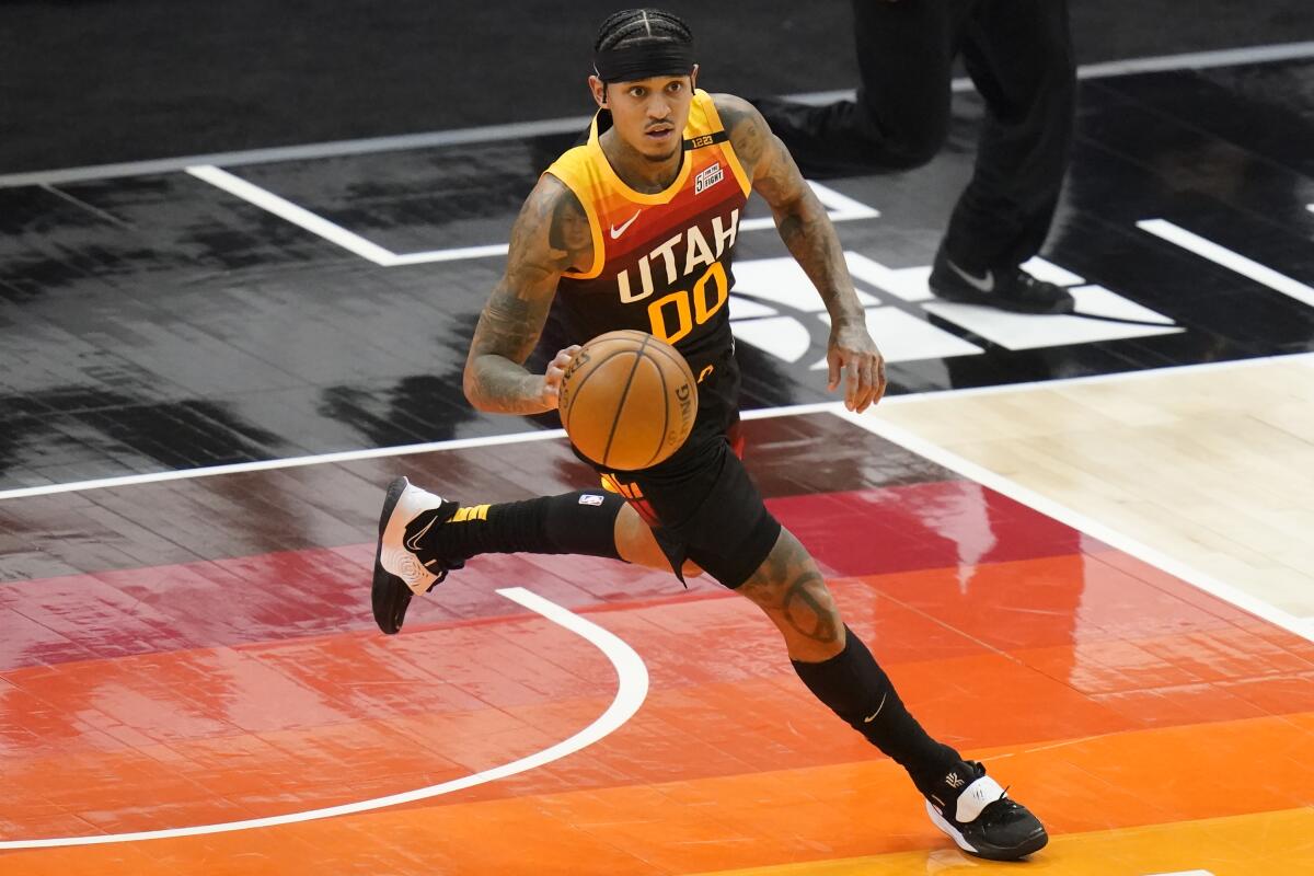 Utah Jazz guard Jordan Clarkson brings the ball up court in the second half during an NBA basketball game.