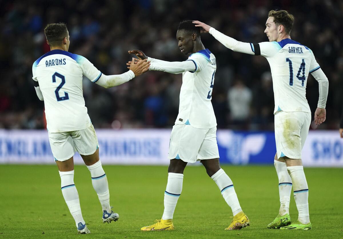 Folarin Balogun, center, celebrates scoring England's first goal during an under-21 match against Germany on Sept. 27, 2022.