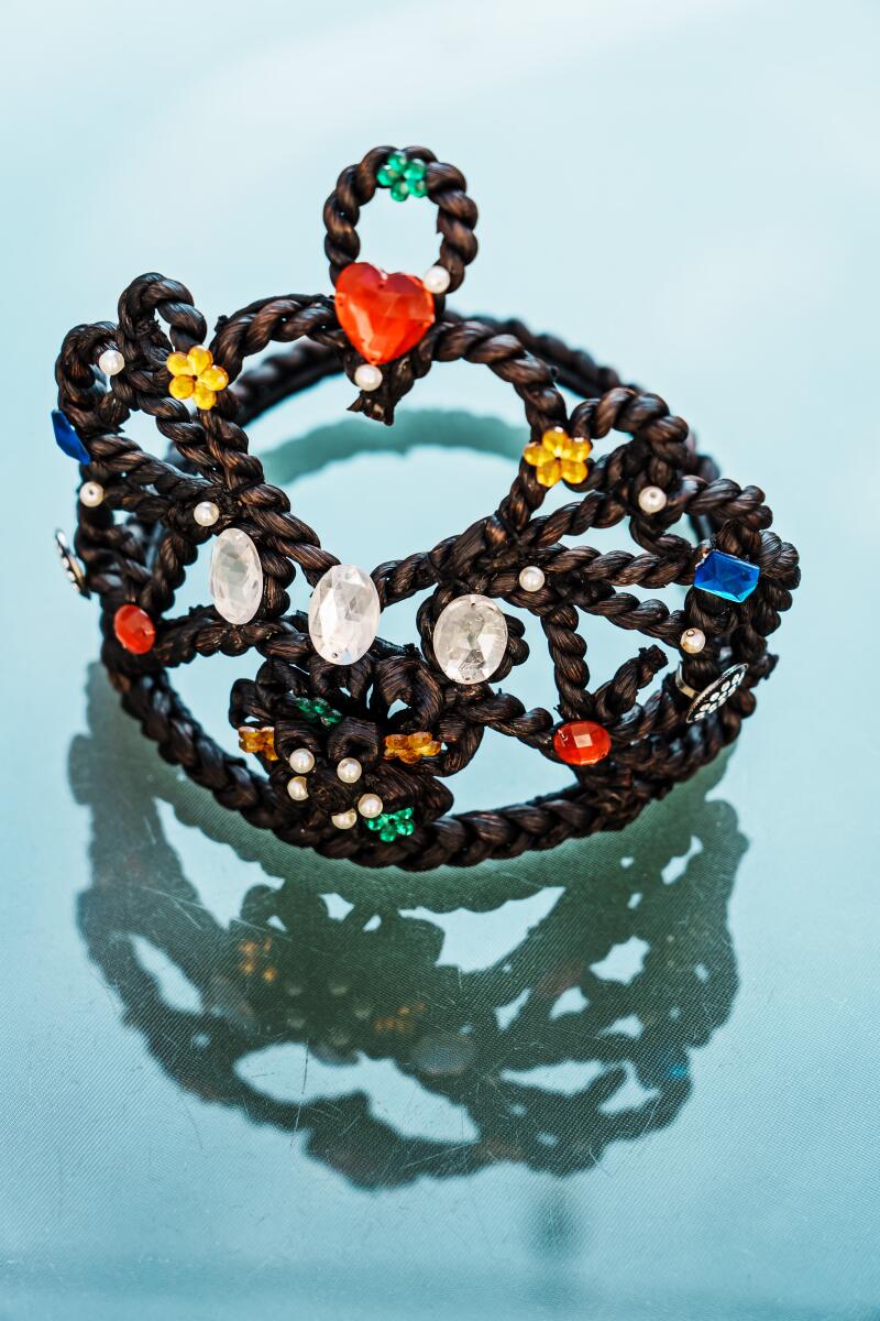 A crown of vanilla embellished with large jeweled ornaments.