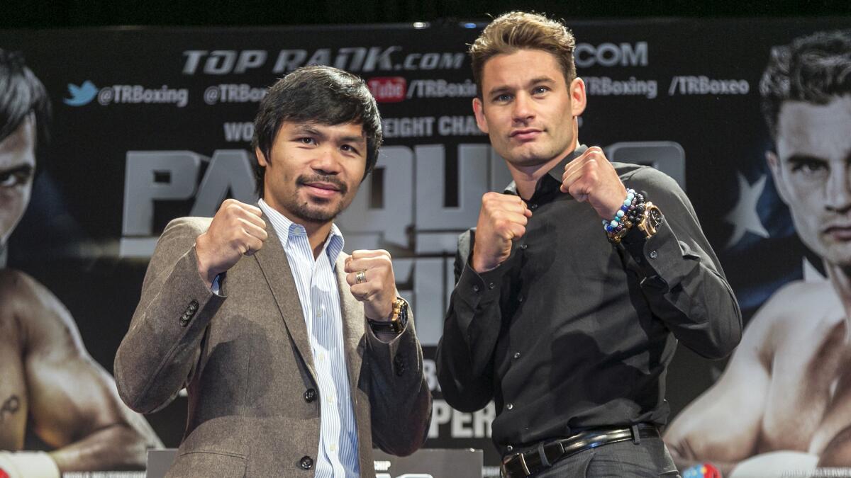 Manny Pacquiao, left, and Chris Algieri pose for a photo in Los Angeles on Sept. 3 to promote their scheduled title fight Saturday in Macao.