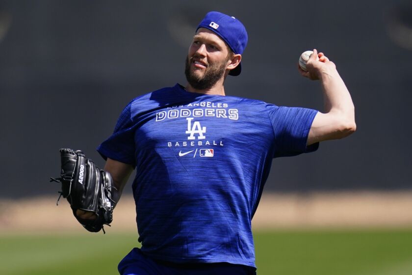 Los Angeles Dodgers pitcher Clayton Kershaw warms up during a spring training baseball workout.