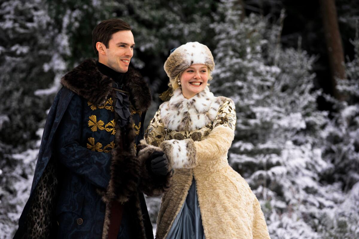 A couple in fur coats smile outside in the snow in a scene from "The Great."