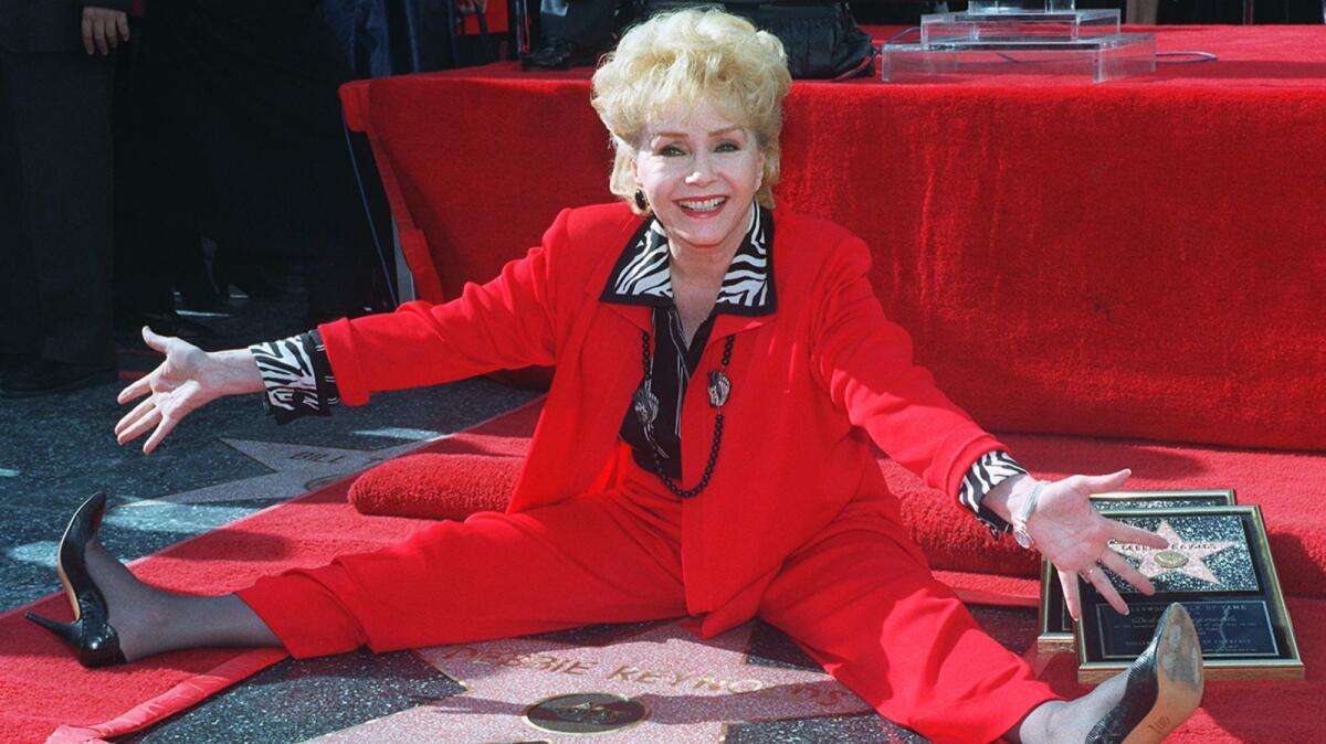 Veteran stage and film actress Debbie Reynolds poses with her second star on the Hollywood Walk of Fame on Jan. 13, 1997.