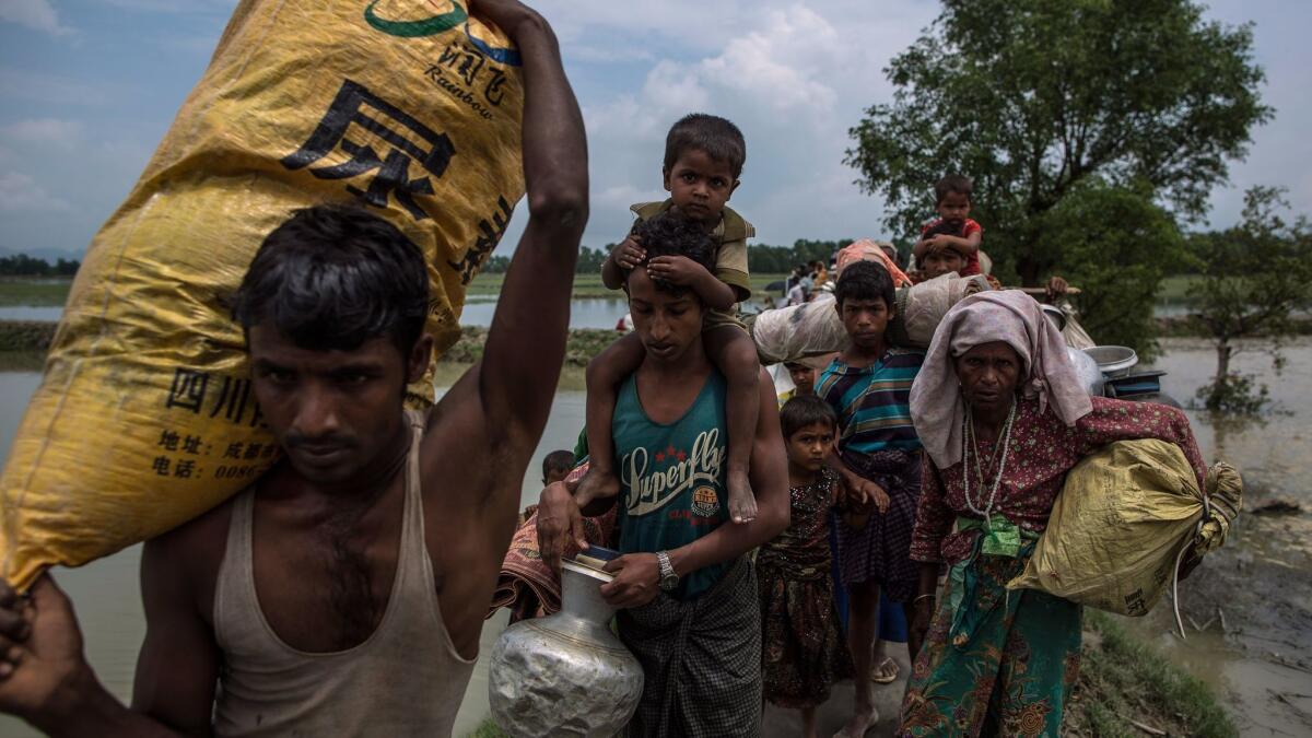 Rohingya Muslim refugees make their way into Bangladesh after crossing the Myanmar-Bangladesh border near Whaikhyang, Bangladesh, on Sept. 7.