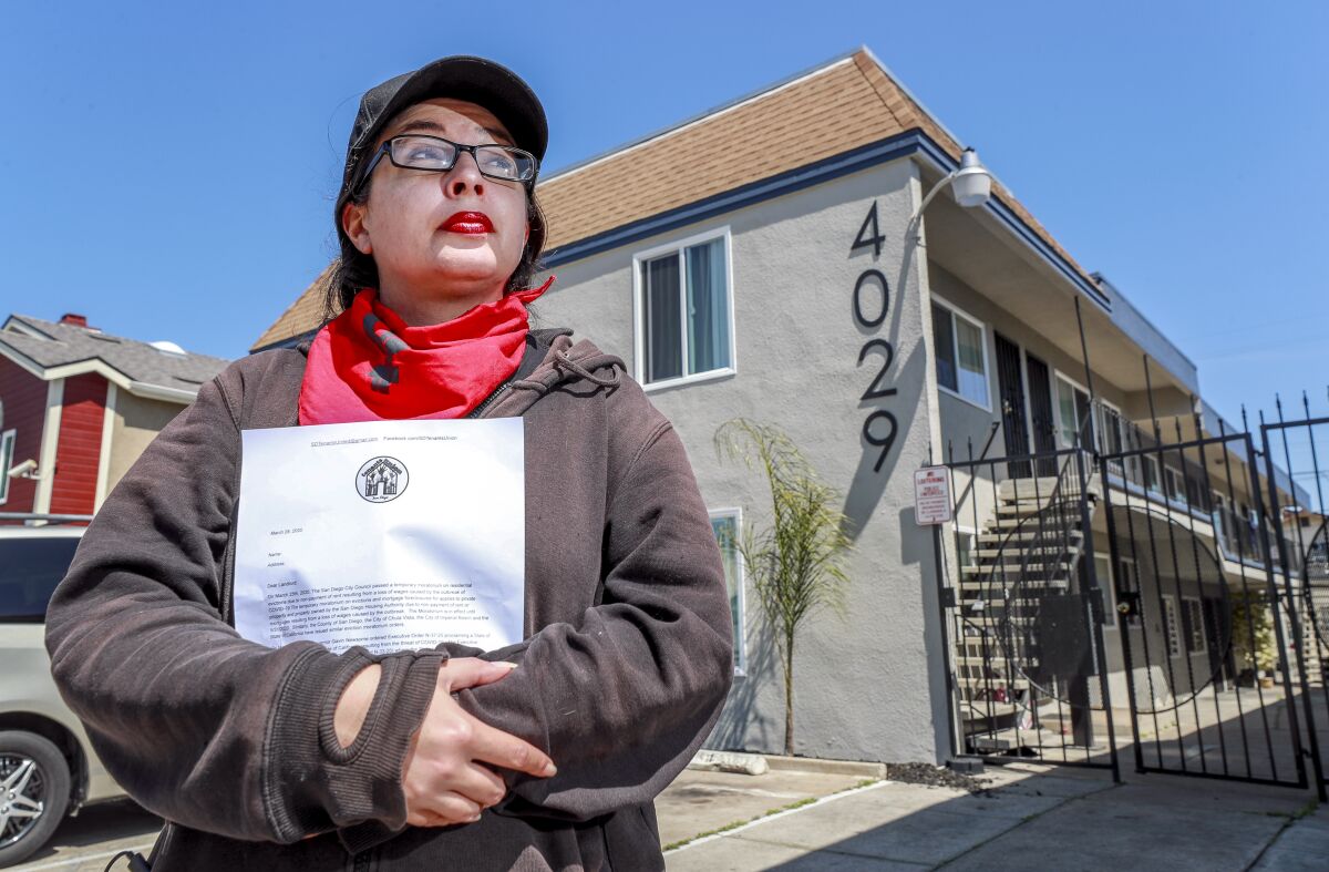 Catherine Mendonça, an administrator with the San Diego Tenant's Union, shows a letter provided by the organization to give to striking renters for their landlords.