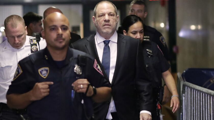 Harvey Weinstein enters the state Supreme Court in New York on Oct. 11. The Oscar-winning movie producer was sued Friday by an anonymous woman who alleged harassment and sexual assault.