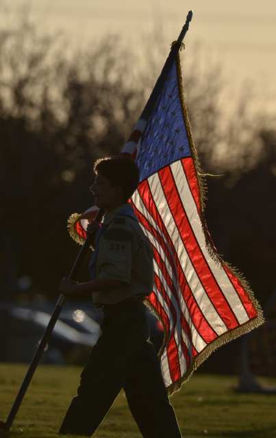 Boy Scout Troop 339's Kendall Kutz, 11 from Costa Mesa carries the flag for the opening ceremony of the Newport-Mesa Friday Night Lights.