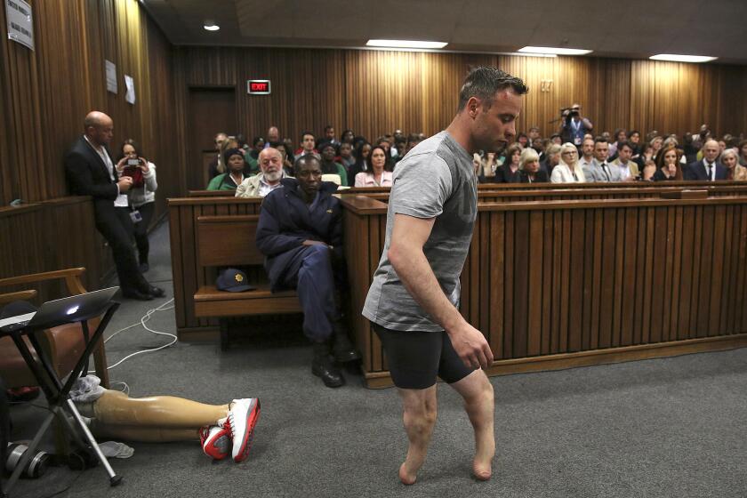 Oscar Pistorius' prosthetics lay on the floor as he walks on his stumps in the High Court in Pretoria, South Africa, on June 15.